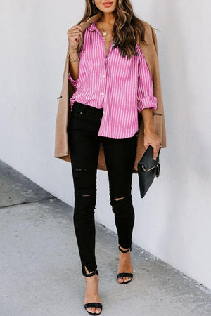 a woman in a pink shirt and black jeans