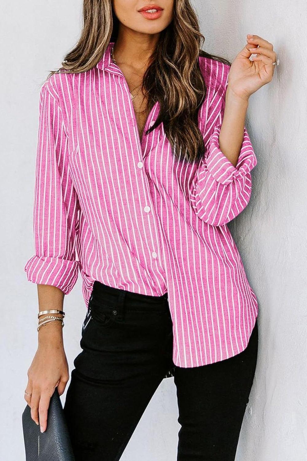 a woman leaning against a wall wearing a pink and white striped shirt