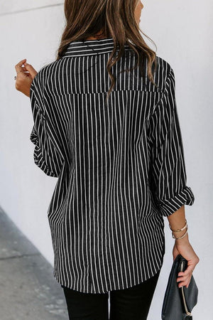 a woman wearing a black and white striped shirt