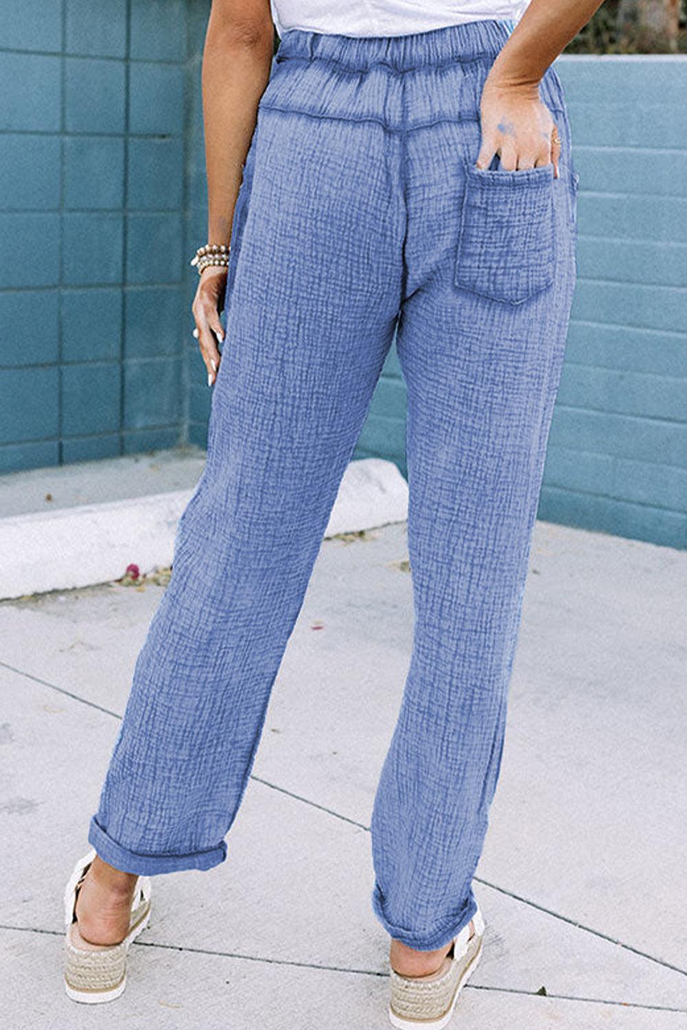 a woman in a white shirt and blue pants