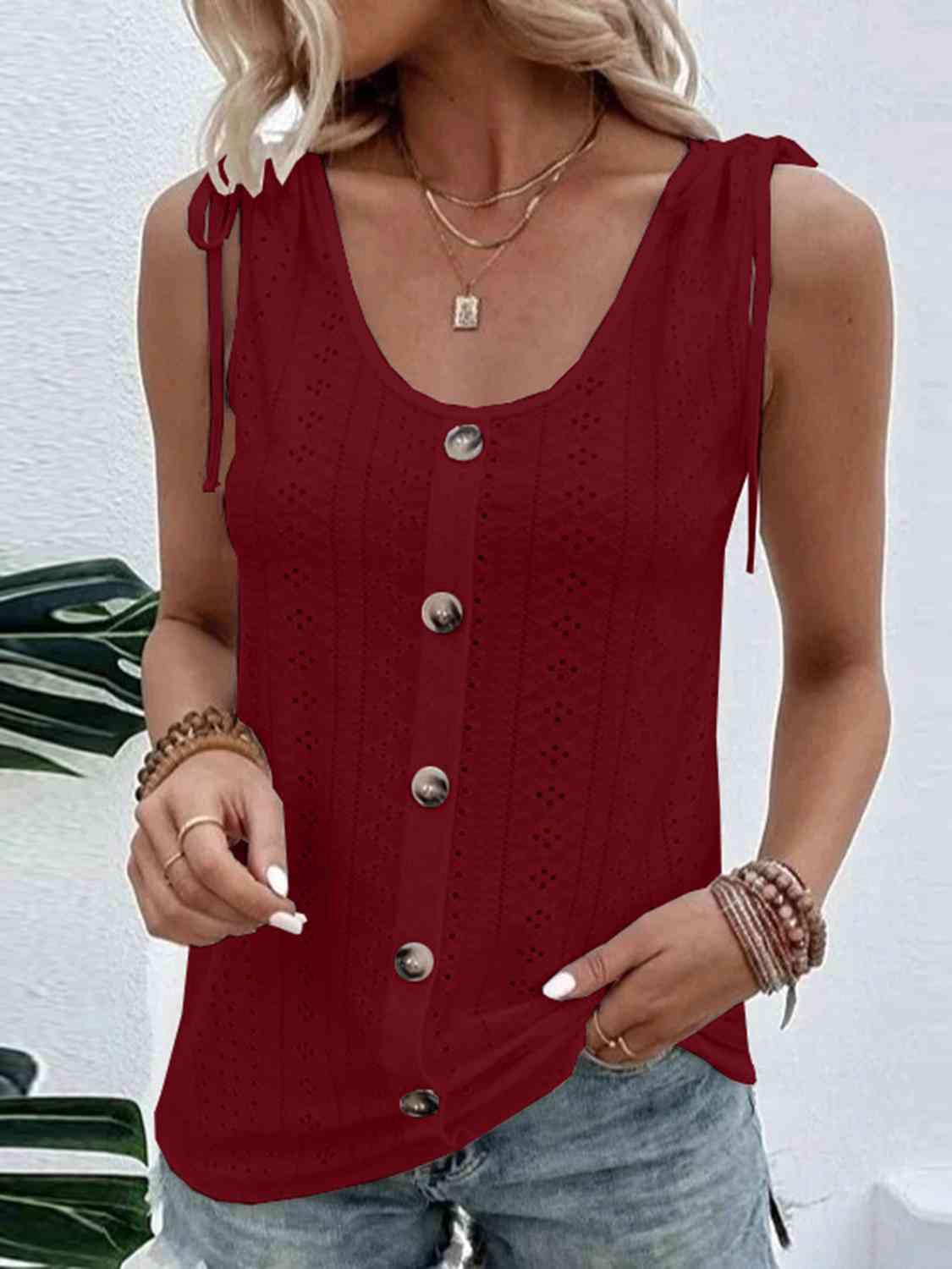 a woman wearing a red tank top with buttons