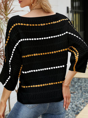 a woman wearing a black and yellow sweater