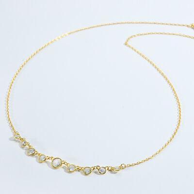 a gold necklace with five stones on a white background