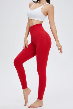 a woman in a white top and red leggings