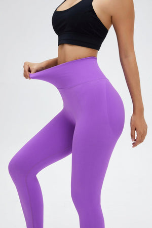 a woman in a black top and purple leggings