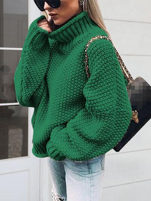 a woman in a green sweater smoking a cigarette