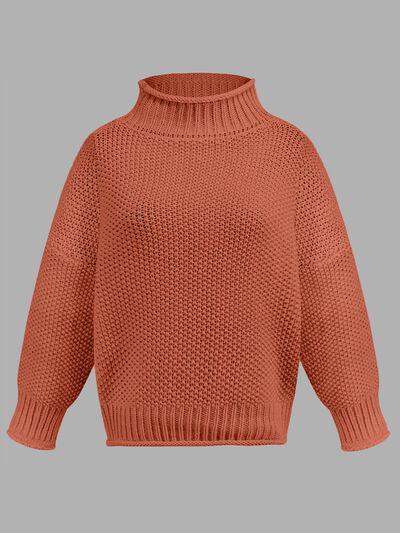 a woman wearing an orange sweater with a turtle neck