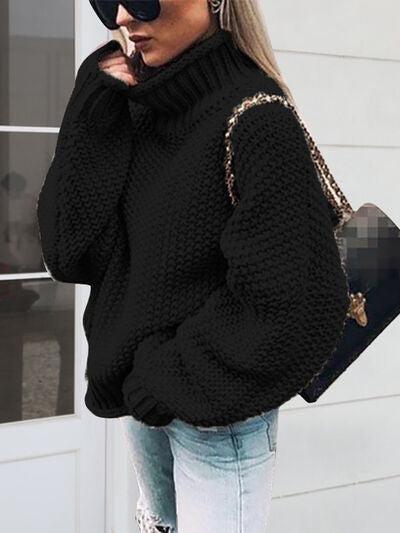 a woman in a black sweater smoking a cigarette