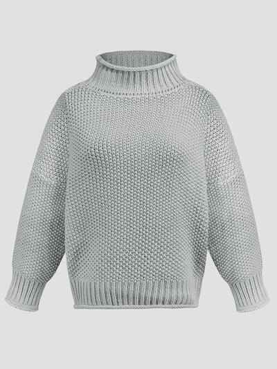a white sweater with a high neck and long sleeves