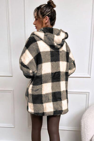 a woman wearing a black and white checkered coat