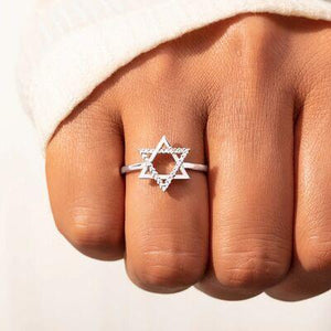 a person wearing a ring with a star of david on it