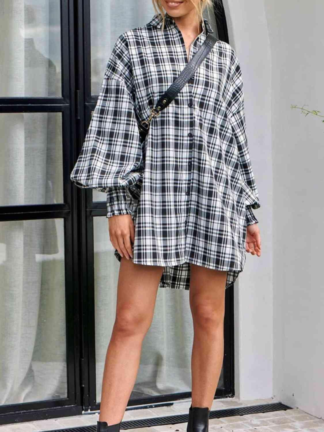 a woman standing in front of a window wearing a black and white checkered shirt