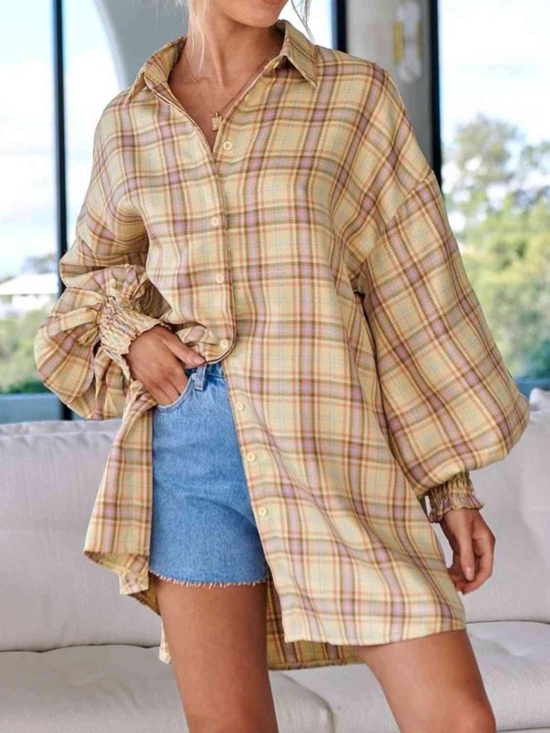 a woman wearing a plaid shirt and denim shorts