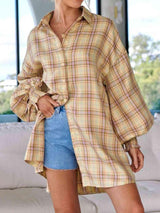 a woman wearing a plaid shirt and denim shorts