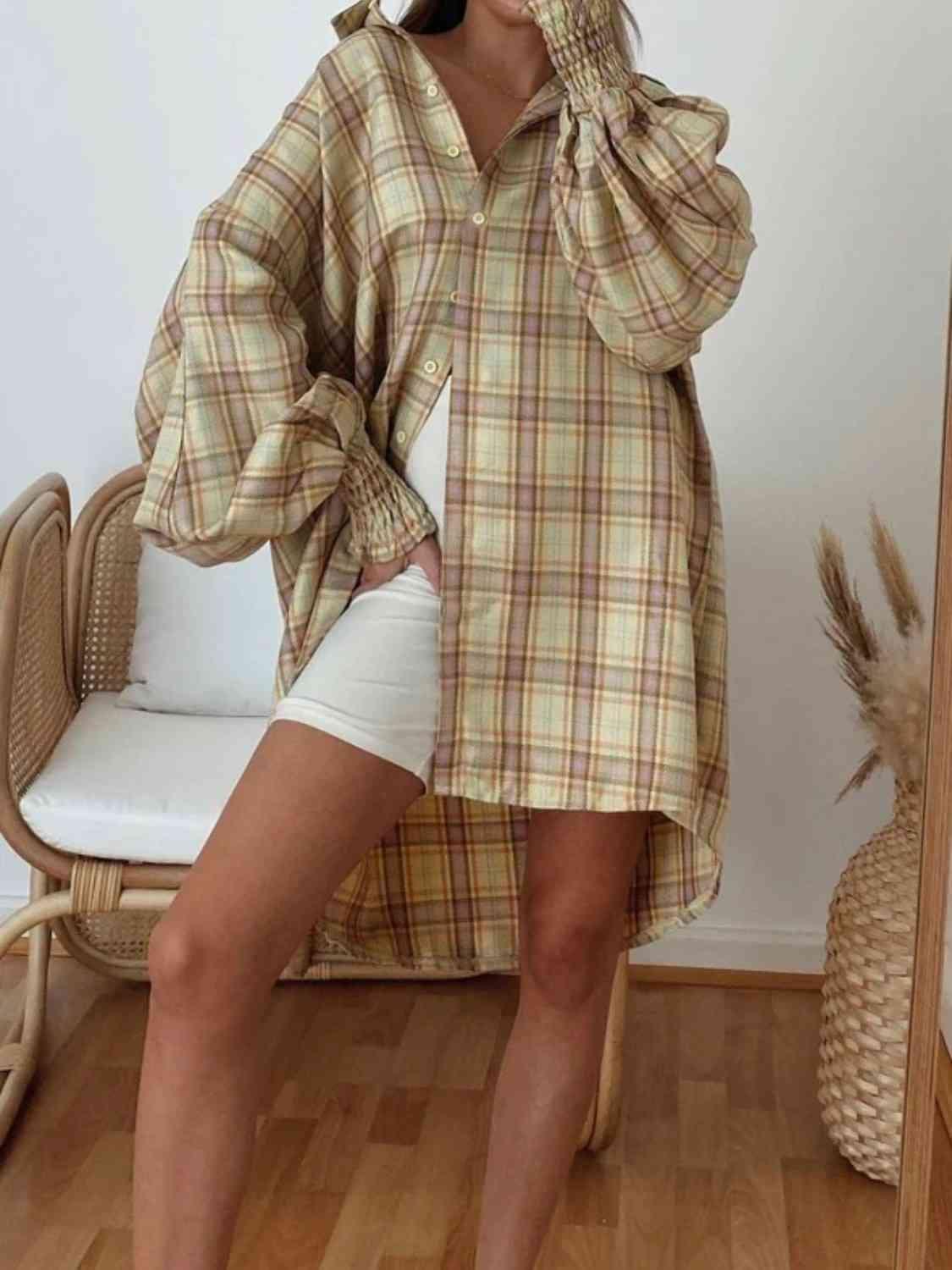 a woman wearing a plaid shirt and white shorts