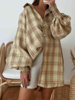 a woman brushing her teeth while wearing a plaid shirt