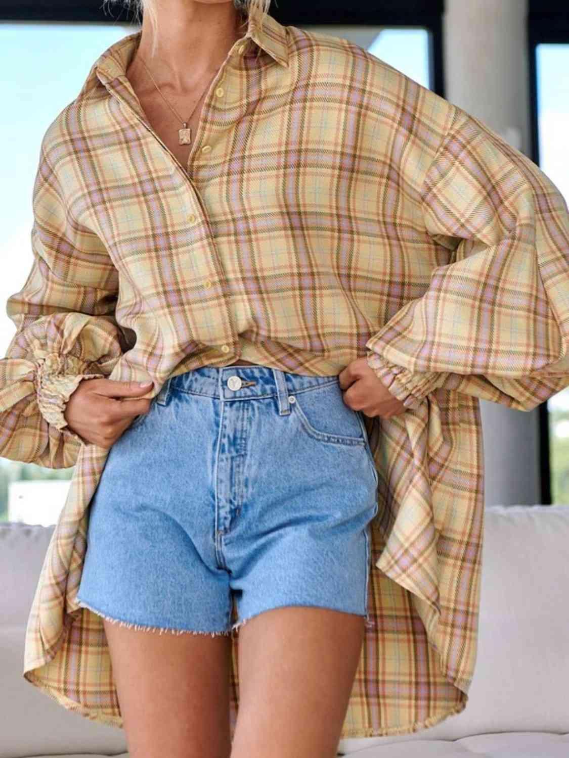 a woman wearing a plaid shirt and denim shorts