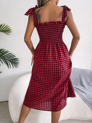 a woman wearing a red and black checkered dress