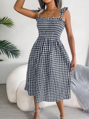 a woman wearing a black and white checkered dress