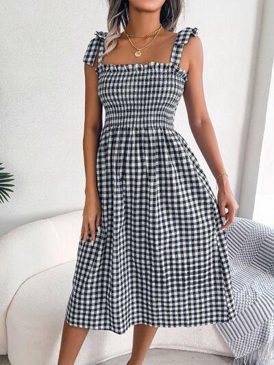 a woman wearing a black and white checkered dress