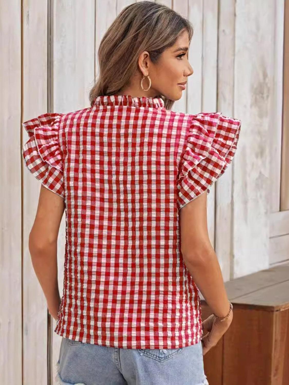 a woman wearing a red and white checkered shirt
