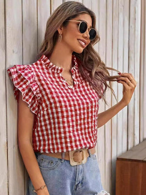 a woman wearing a red and white checkered shirt