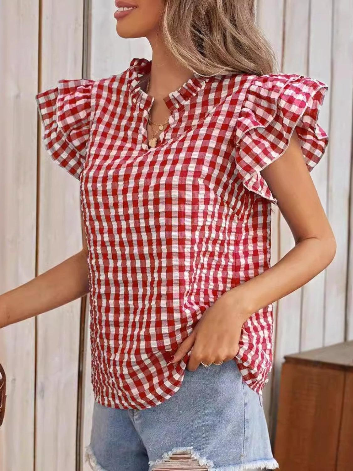 a woman wearing a red and white checkered top