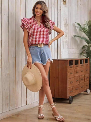 a woman standing in a room with a hat