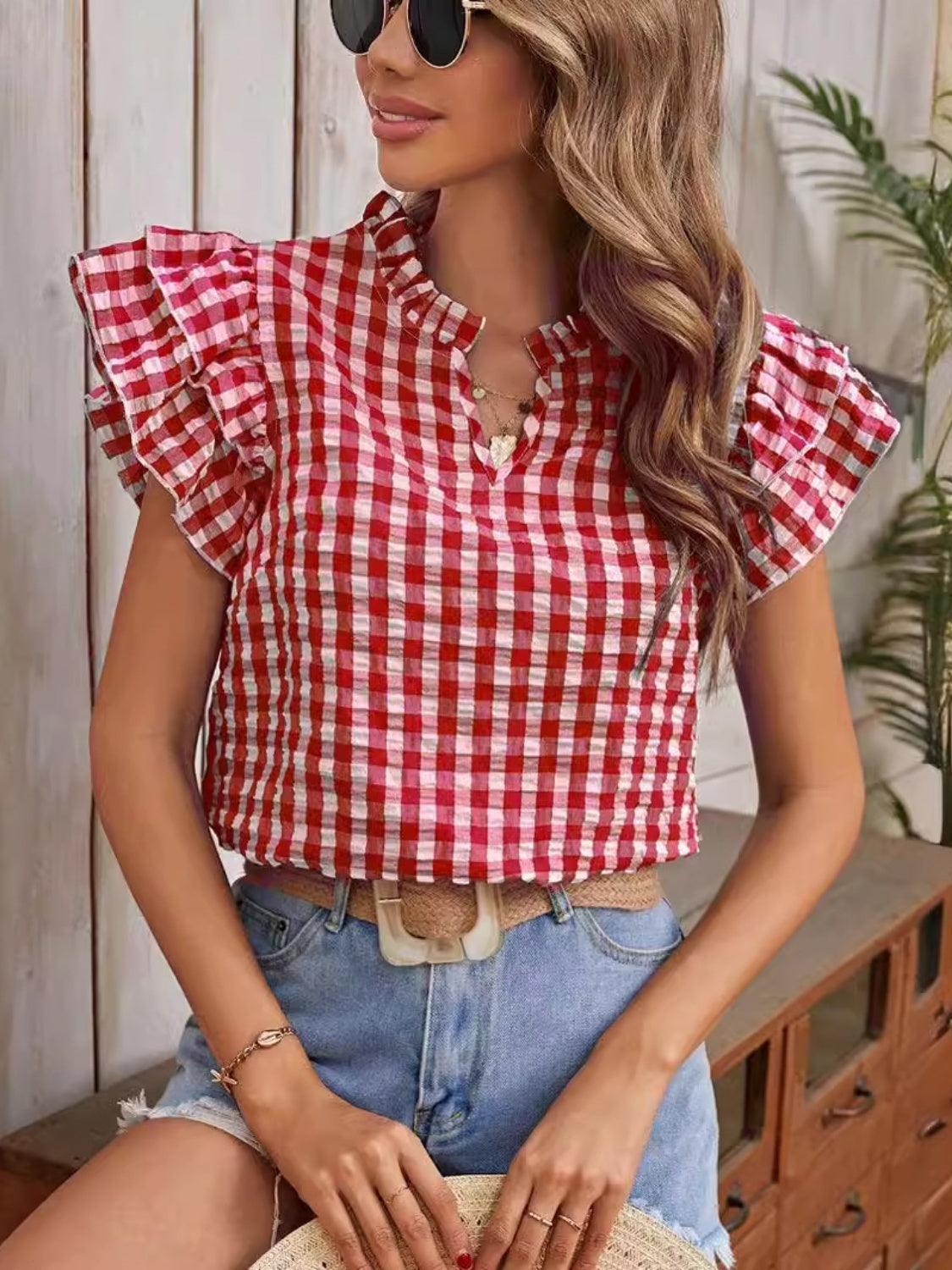 a woman wearing a red and white checkered top