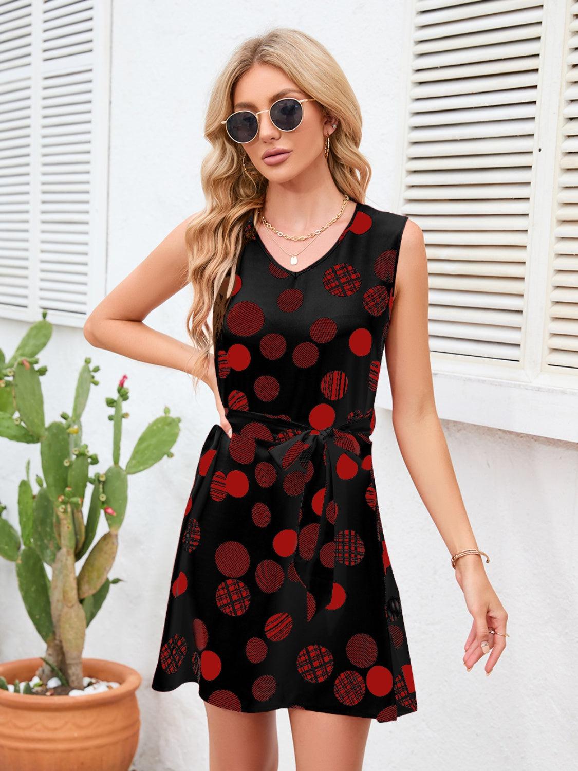 a woman wearing a black and red polka dot dress