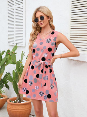 a woman wearing a pink polka dot dress