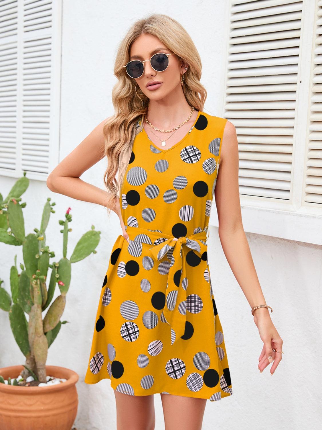 a woman wearing a yellow polka dot dress