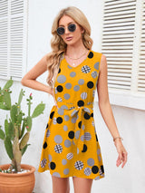 a woman wearing a yellow polka dot dress