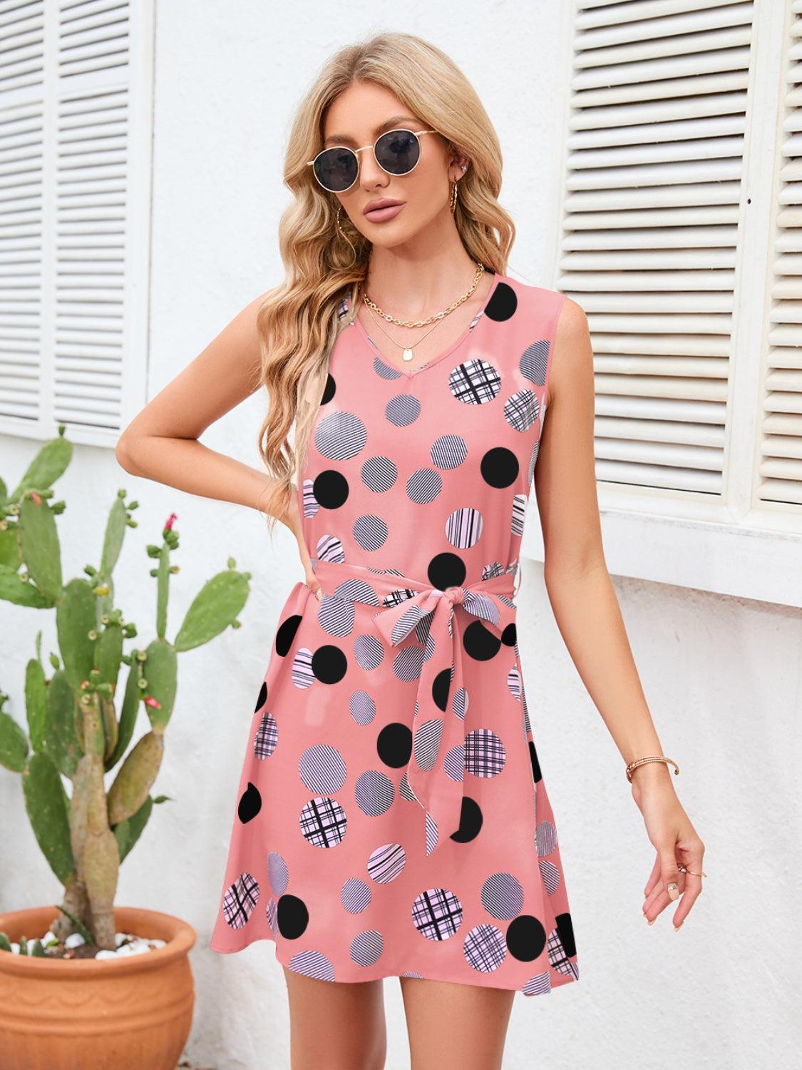 a woman wearing a pink polka dot dress