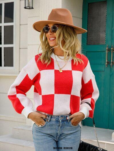 a woman wearing a red and white checkered sweater