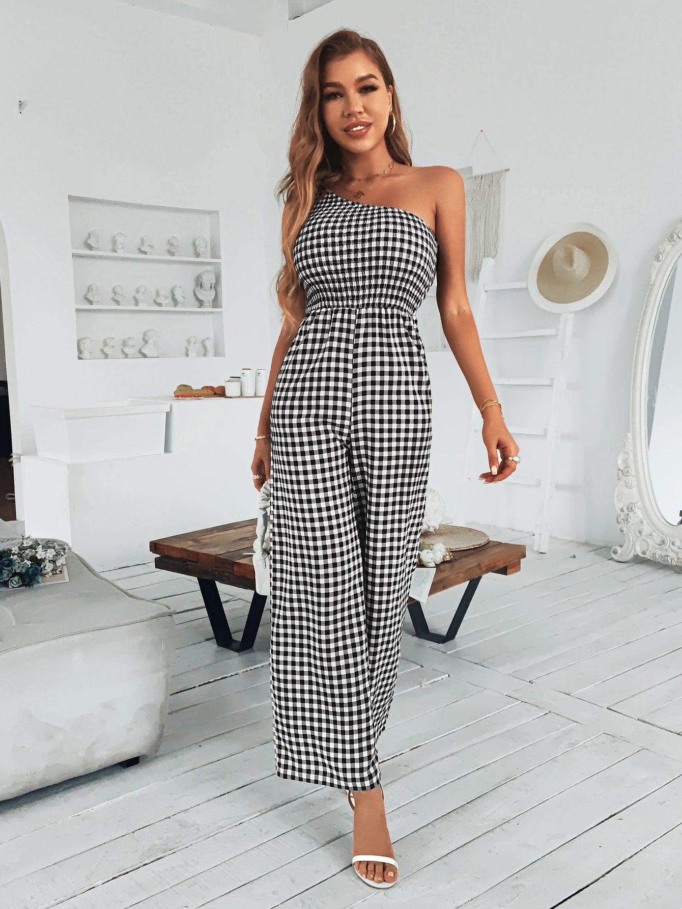 a woman wearing a black and white checkered jumpsuit