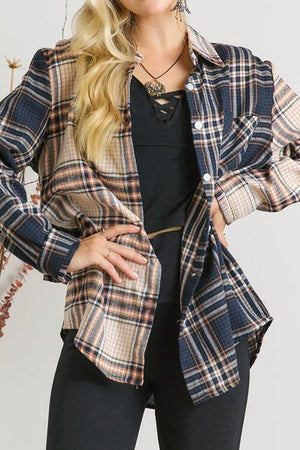 a woman wearing a plaid shirt and black pants