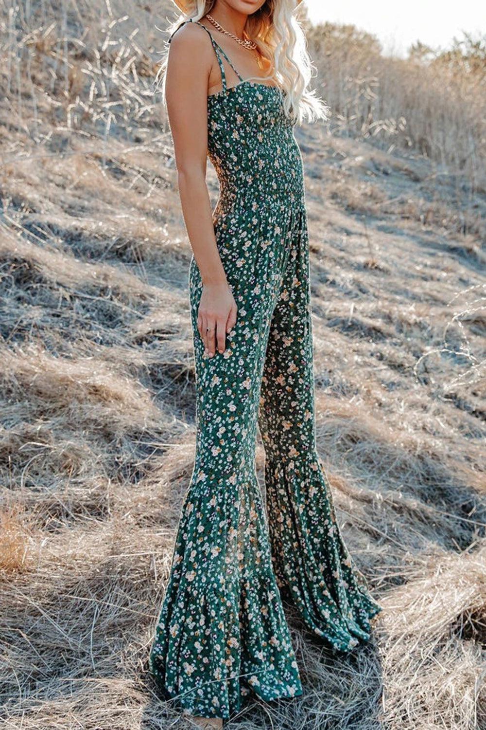 a woman standing in a field wearing a hat