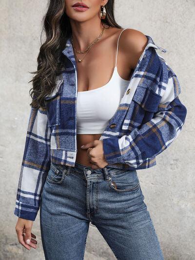 a woman wearing a white top and blue plaid jacket