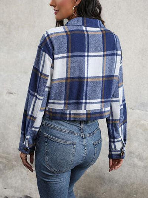 a woman wearing a blue and white plaid shirt