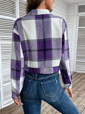 a woman wearing a purple and white checkered jacket