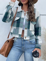 a woman wearing a hat and a plaid jacket