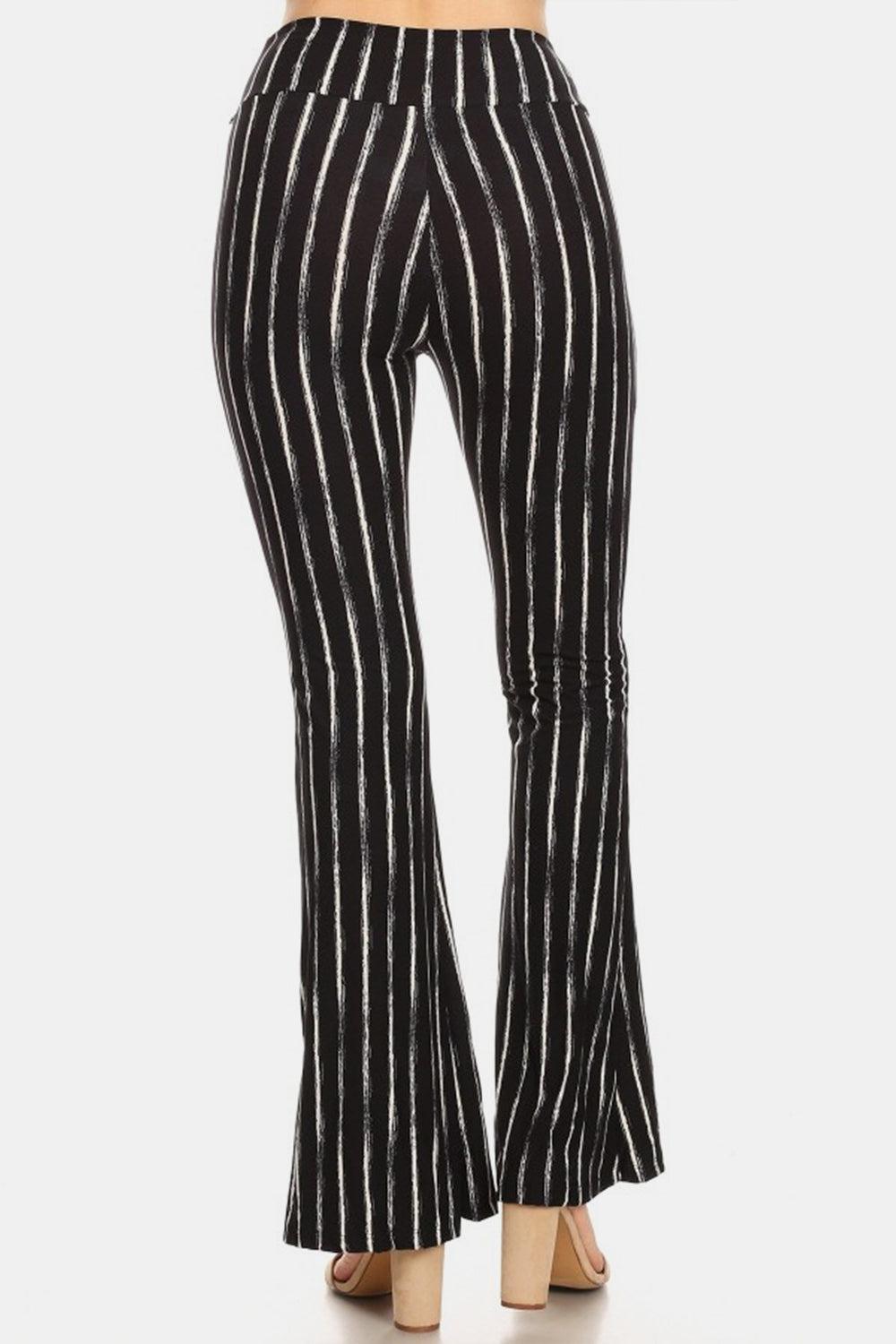 a woman wearing black and white striped pants