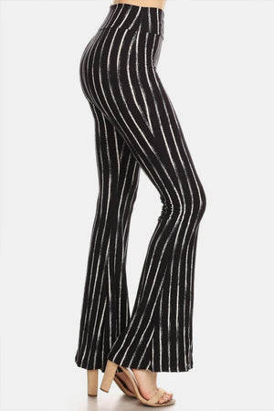 a woman wearing a black and white striped pants