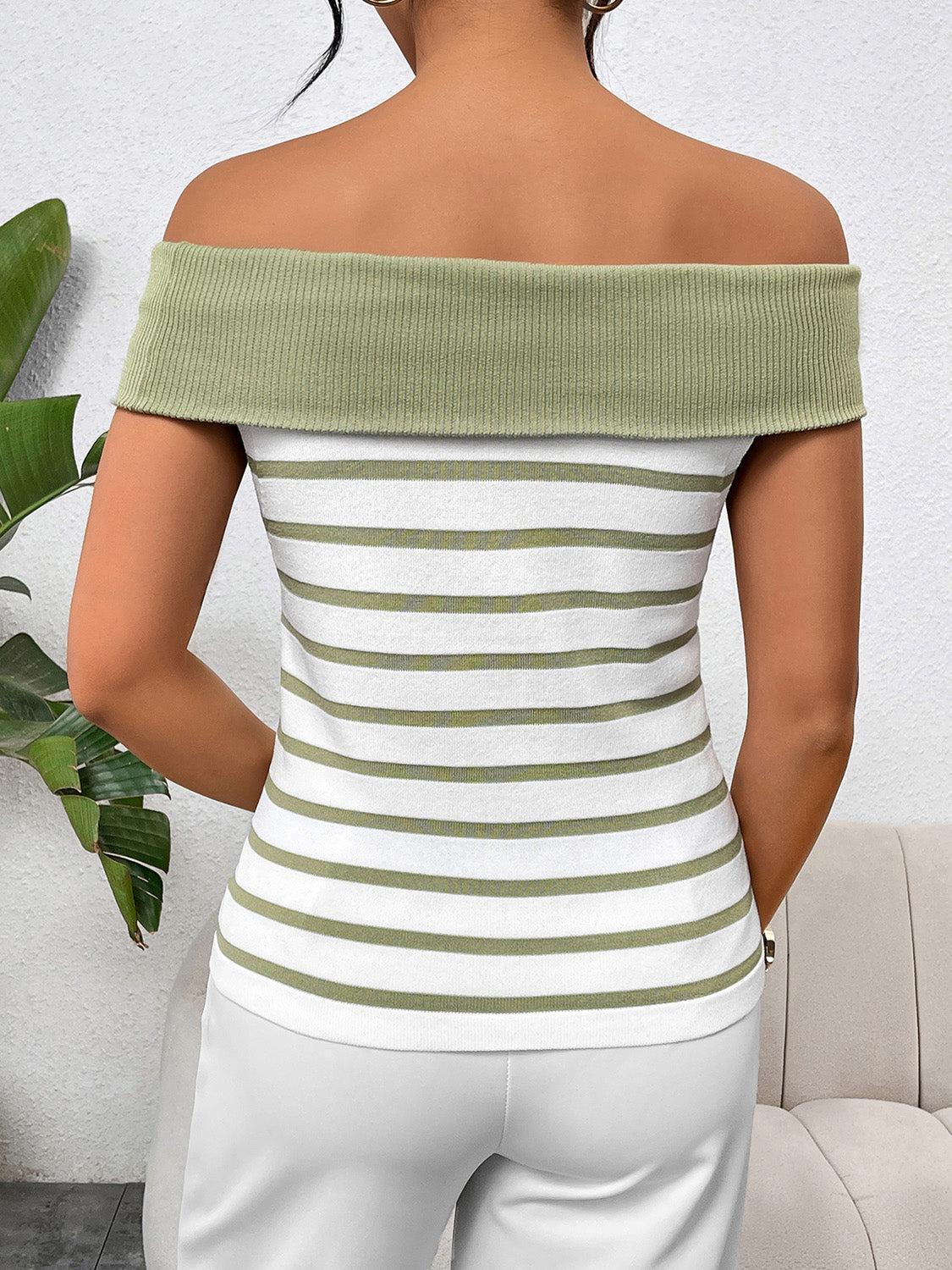 a woman wearing a white and green striped top