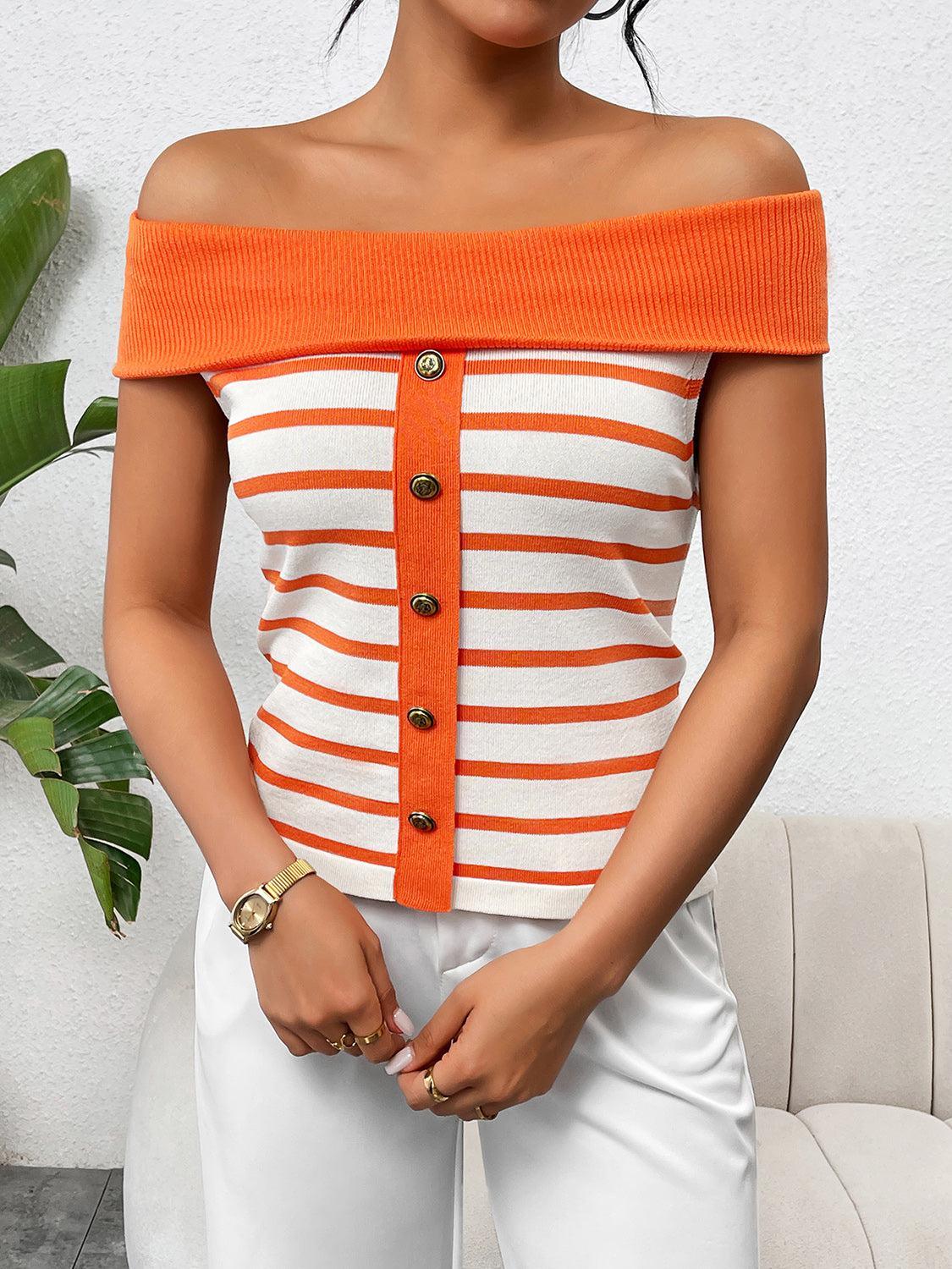 a woman in white pants and an orange striped top