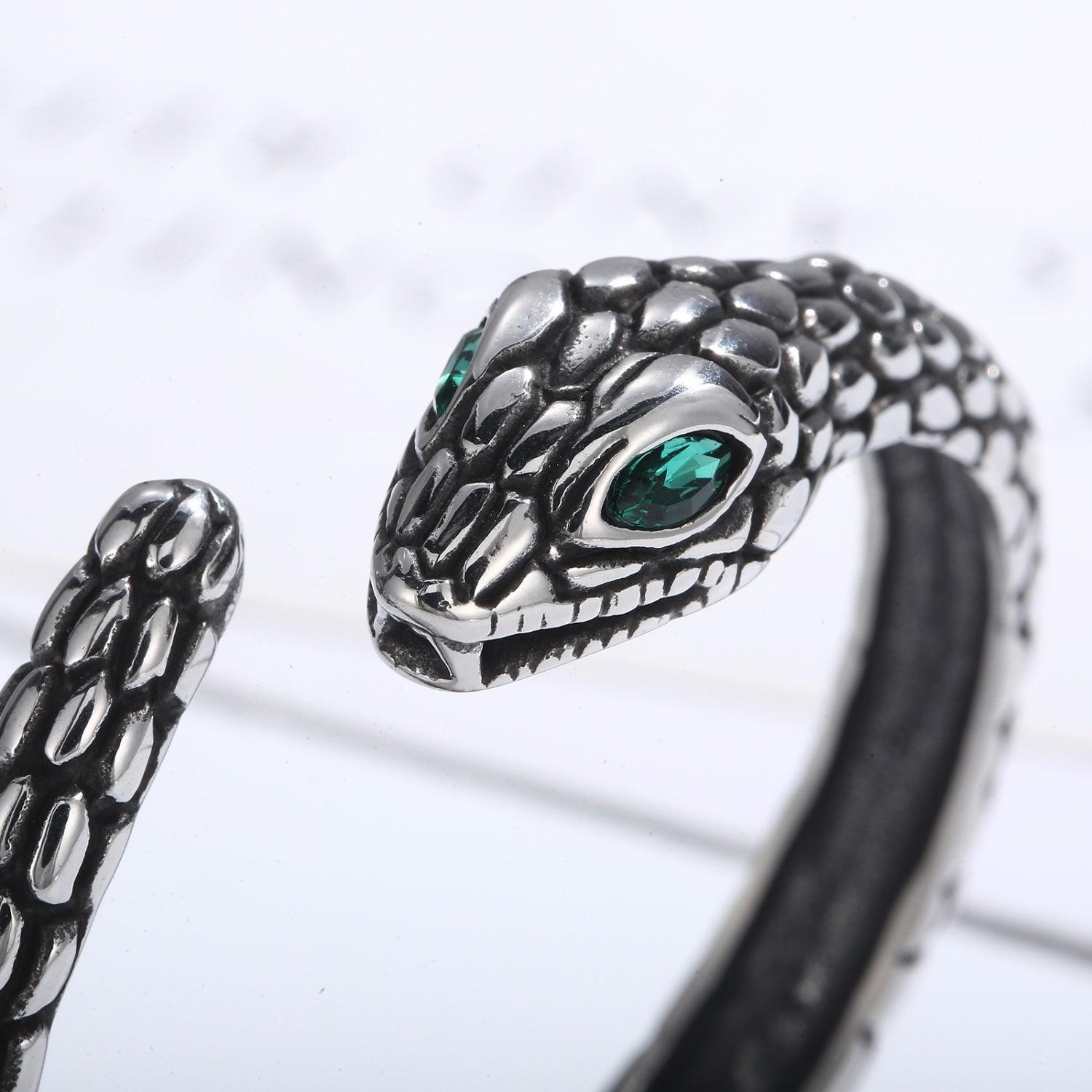 a close up of a bracelet with a snake on it