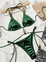 a green bikini top and a zebra print purse