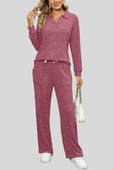 a woman wearing a pink sweater and pants