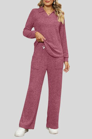 a woman wearing a pink sweater and pants